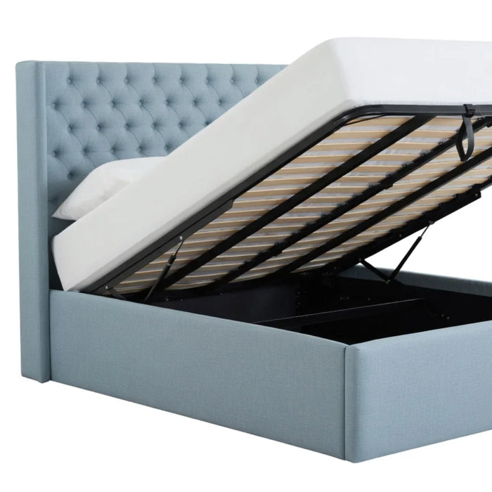 Light blue tufted storage bed with gas lift base fully open, showing spacious storage compartment and wooden slats