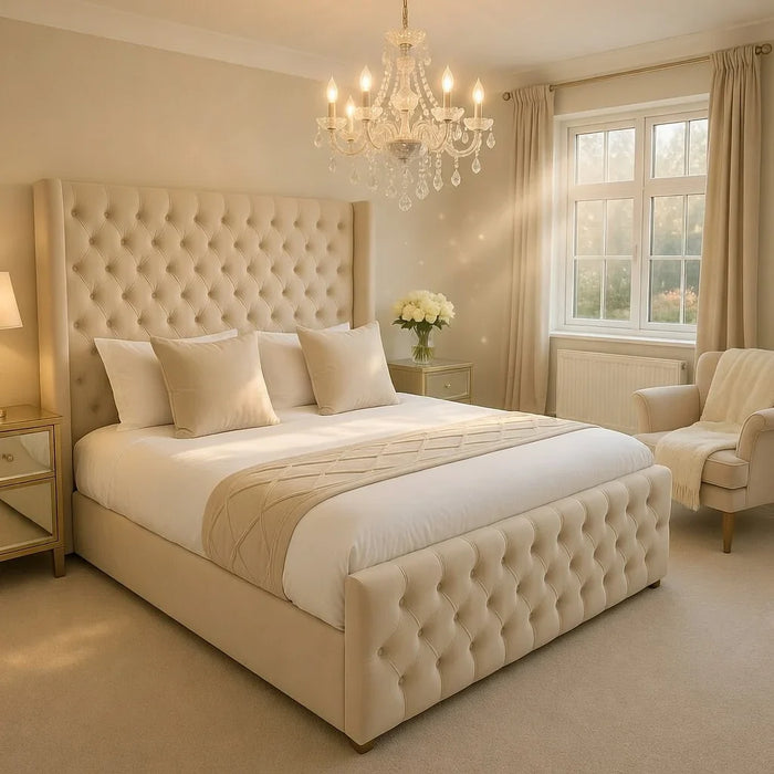 Wide view of The Astoria Cream Velvet Bed Frame in a bright luxurious bedroom with natural light and full room setting
